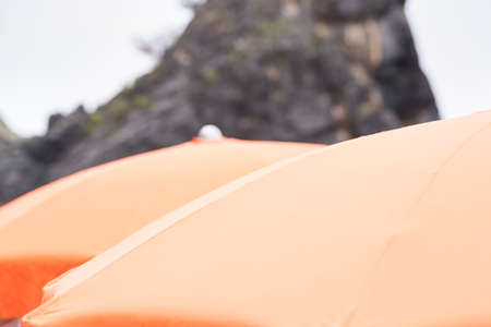 reef of the coast and umbrellas on the beachの写真素材