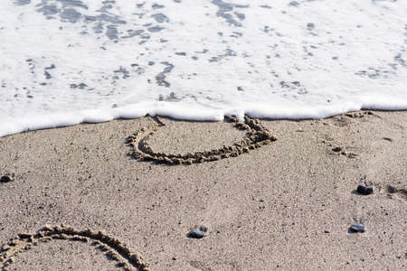heart drawn in the sand love and romanceの写真素材