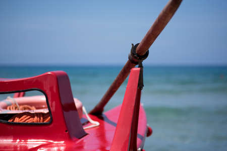 typical wooden rescue boat and rowing in the beaches of southern Italyの写真素材