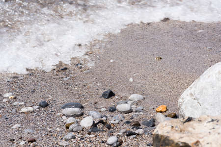 sand texture with small colored pebbles in the backgroundの写真素材