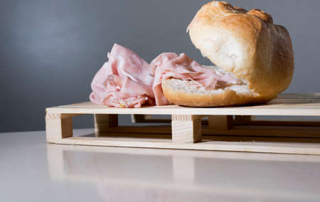 sandwich with mortadella, typical Italian food on the wooden supportの写真素材