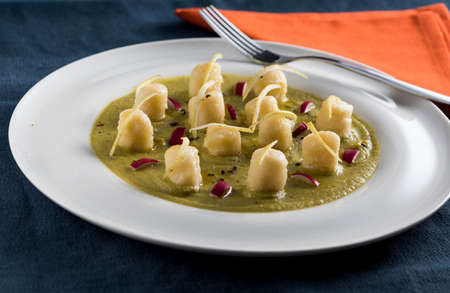 velvety green peas with dumpling, lemon and radicchioの写真素材