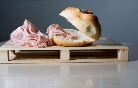 sandwich with mortadella, typical Italian food on the wooden supportの写真素材
