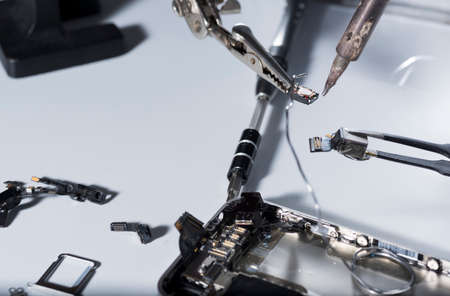 Close up of a repair smartphone with laboratory instruments