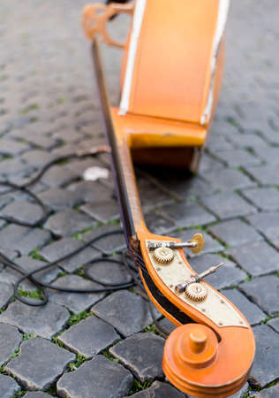 contrabass laid on cobblestones in Rome. The music for the roadの写真素材