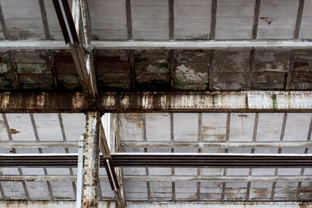 mold and rust on structures and walls of an industrial warehouse