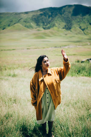 Beautiful woman enjoying the green valleyの写真素材