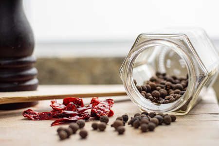 Gourmet ingredients pepper, spices, seasonings on a wooden tableの写真素材