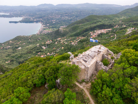 Ruined building overlooking a coastal town in Greece.の写真素材