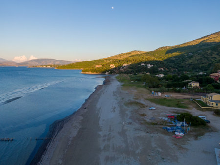 Serene coastal view with sandy beach and hillsideの写真素材