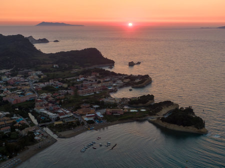 Aerial sunset view of coastal town and tranquil seaの写真素材