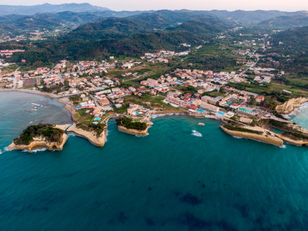 Aerial view of coastal town with unique rock formations and turquoise water.の写真素材