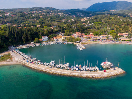 Scenic harbor filled with boats, nestled in a picturesque coastal town.の写真素材