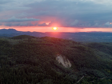 Sunset over rolling hills with vibrant colors.の写真素材