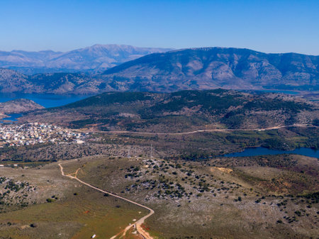 Panoramic view of mountains, lake, and town nestled in a valley.の写真素材