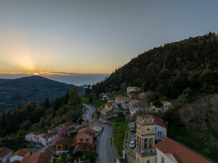 Sunset over a hillside village nestled in mountainsの写真素材