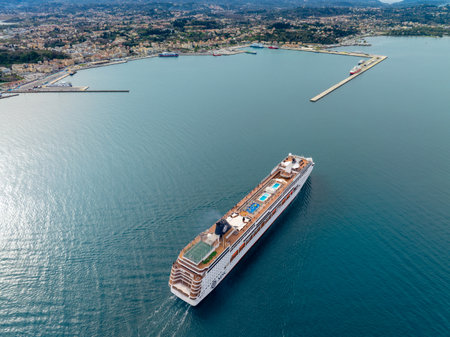 Cruise ship approaching a coastal city harbor.の写真素材