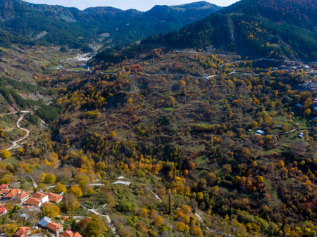 Autumnal village nestled in a mountain valley.の写真素材
