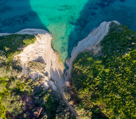Aerial view of a secluded cove with turquoise water and sandy shores.の写真素材