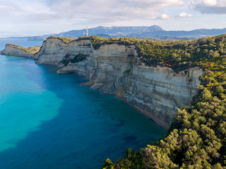 Dramatic cliffs meet turquoise waters in a stunning coastal landscape.の写真素材