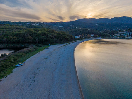 Serene sunset over a secluded beach cove.の写真素材