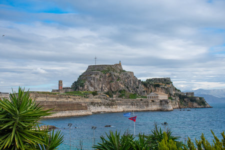 Picturesque view of an ancient fortress perched atop a rocky hill overlooking the vast expanse of the sea.の写真素材