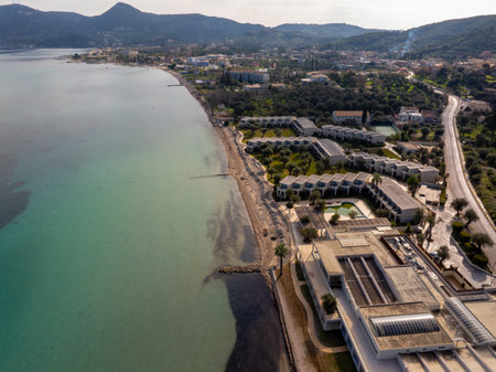 Aerial view of a resort and sandy beach with clear turquoise water along a coast in an idyllic setting.の写真素材