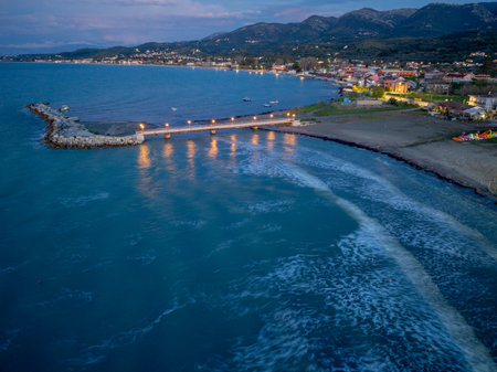 Picturesque coastal scene with a bridge extending into the water at dusk. A tranquil evening view.の写真素材