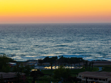 Scenic ocean view at dusk, captured from a high vantage point, featuring a tranquil resort setting.の写真素材