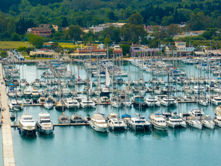 Dense marina filled with various boats and yachts docked in clear blue water on a sunny day.の写真素材