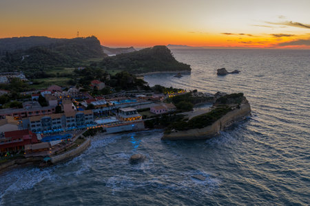 Coastal paradise at sunset: A scenic view of oceanfront villas nestled along the rugged coastline.