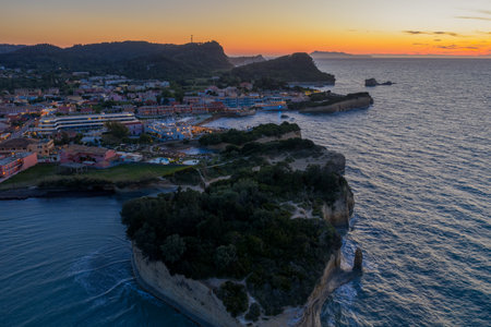 Picturesque coastal town at sunset featuring cliffs, ocean views, and charming architecture.の写真素材