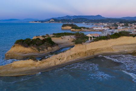 Beautiful oceanfront rock formations along the coastline during sunset creating picturesque scenery.