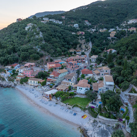Coastal Village Nestled Between the Azure Sea and Lush Green Hillside at Dusk, a serene retreat.の写真素材