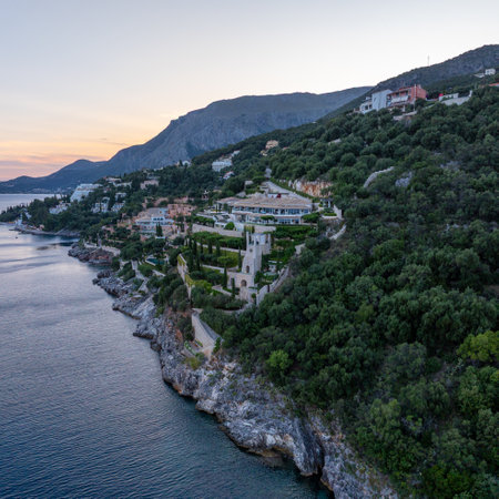 Coastal Cliffside Estate: A luxurious villa complex nestled on a hillside overlooking the sea.の写真素材