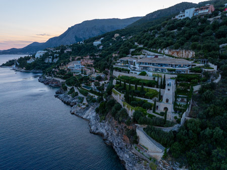 Coastal luxury: Cliffside villas cascade down to the sea, blending architecture with natural beauty.の写真素材