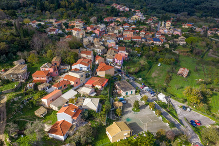 Colorful traditional houses and village parking area in Pagi Corfu Greece seen from above aerial drone photography of rural Greek settlementの写真素材