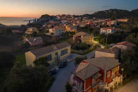 Aerial view of traditional houses and streets in Makrades village Corfu Greece at sunset,...