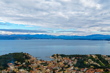 Breathtaking Aerial Seascape of Kassiopi Coastline and Distant Albanian Mountains on Corfu Island Greeceの写真素材