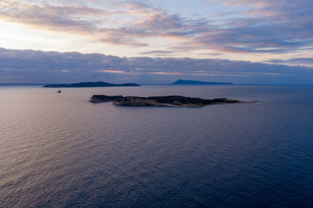 Minimalist aerial seascape view of the Diapontia Islands on the horizon at dusk from Agios Stefanos...