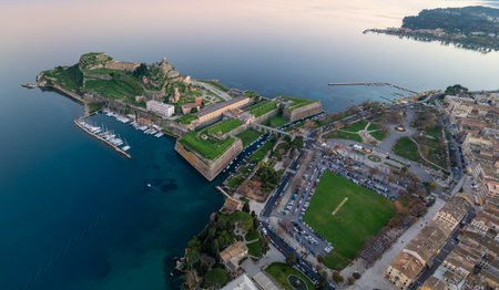 Aerial view of the Old Fortress in Corfu Town, Greece, a UNESCO World Heritage Site. Panoramic landscape of historic Kerkyra city, Ionian Sea, and marina at sunset.の写真素材