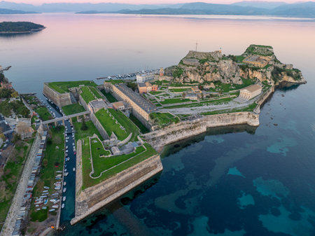 Ancient Old Fortress of Corfu Palaio Frourio Aerial View. Massive Venetian Defensive Stone Walls and Moat Protecting the Historic Town of Kerkyra on the Ionian Island Coastline.の写真素材