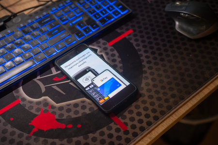 Smartphone screen displaying Google Pay contactless payment interface setup on office desk with...