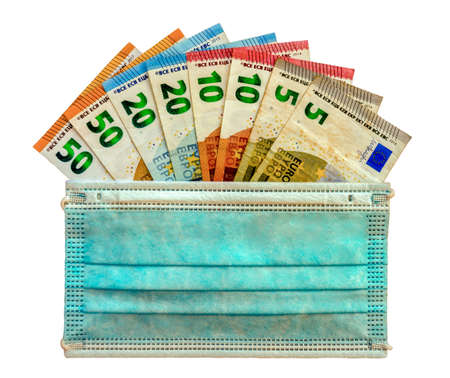 Closed hand with index and middle finger, crossed and a light blue glove, with white background. Luck concept.の写真素材