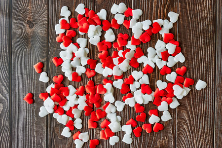 Group of red and white hearts on a wooden table. Concept of love, romanticism, valentine's day, passion.の写真素材