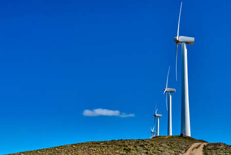 Wind turbines, producing electricity, in an ecological way. Copy space.