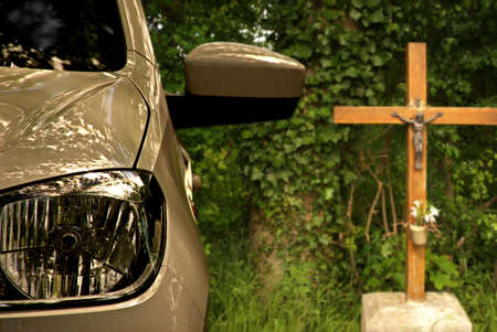 Parking car with crucifix in the background. Drive carefully!の写真素材