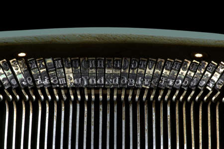 Close-up of the letters of an old typewriter in front of a black backgroundの写真素材