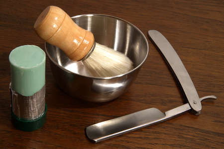 Closeup of an open razor with shaving brush, soap dish and shaving soapの写真素材