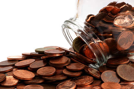 Partial view on a pile of coins with glass to collectの写真素材